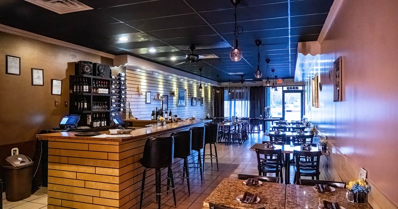 Bar area, chairs and tables on the right