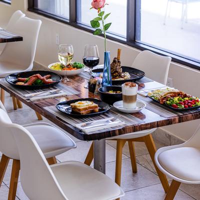 Dining table with various food and drinks.