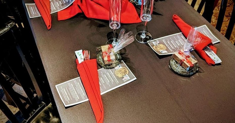Dining table, with glasses, napkins, and utensils