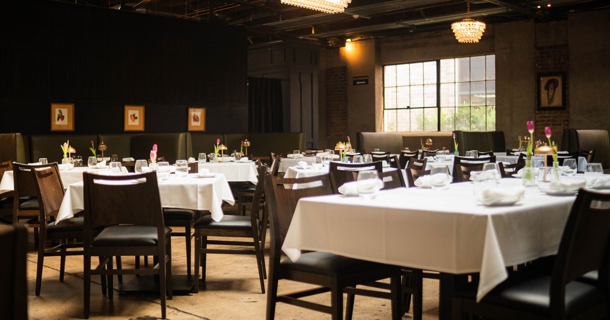 Interior of an elegant and cozy dining area with set tables ready for guests
