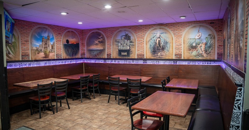 Restaurant interior with wooden tables, black chairs