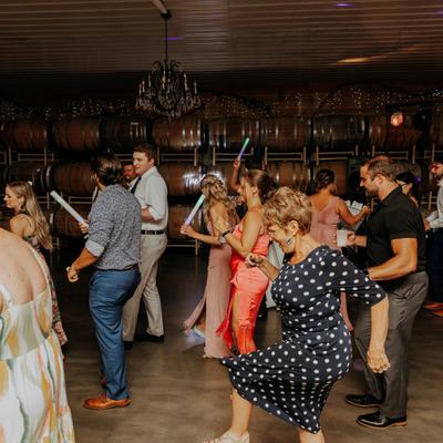 People dancing with glow sticks at Next Chapter Winery.