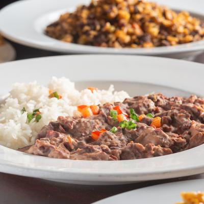 Red beans and Rice with dirty rice plate in the background.