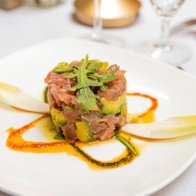 Tuna Tartare with avocado, arugula, lemon juice and drizzle of sauces.