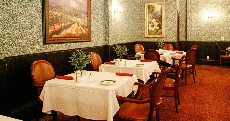 Inside, dining tables ready for guests, pictures