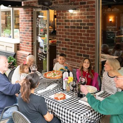 Lots of guests at a table outside.