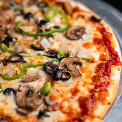Mushroom and olive pizza topped with green peppers.