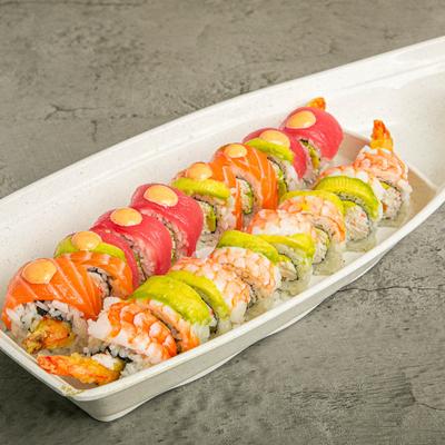 Tuna, salmon, and shrimp sushi rolls on a a plate.