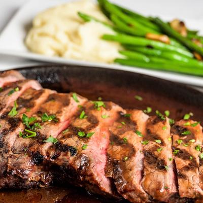NY Strip Steak served with garlic mashed potatoes and sauteed string beans.