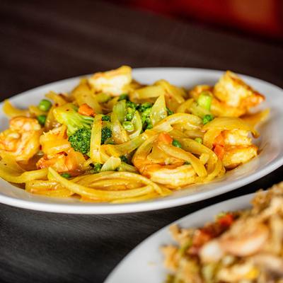 Curry Shrimp, sauteed with broccoli, sliced onions, peas, and carrots.