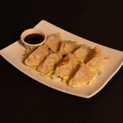 Pan fried dumplings and dip.