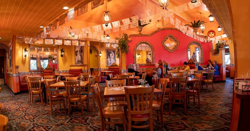 Interior, dining area, tables for four, carpet flooring, Mexican inspired decoration