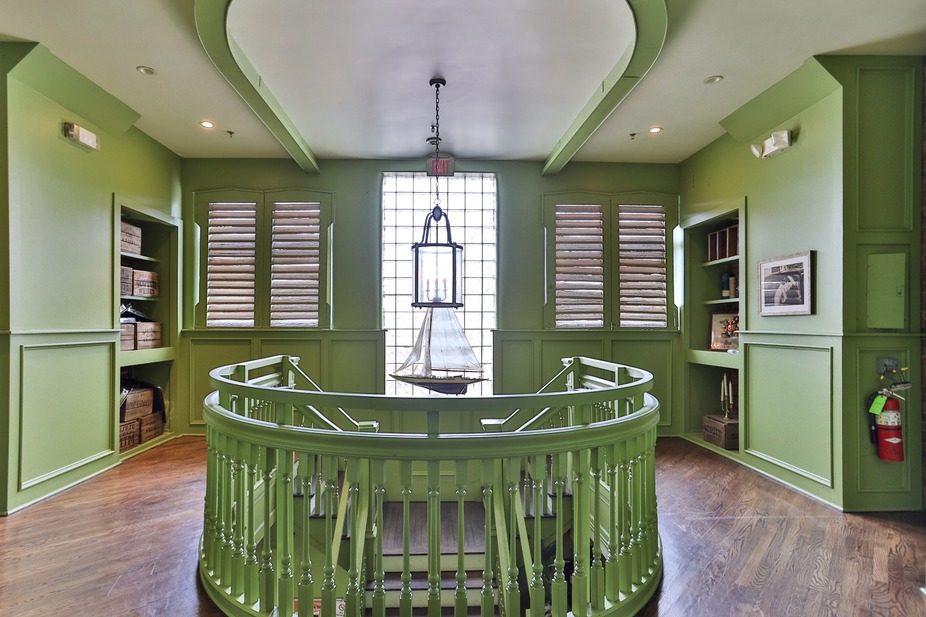 Curved green staircase railing.