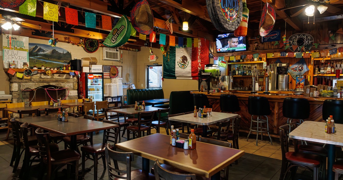 Spacious and cozy Mexican-style interior dining area with tables ready for guests