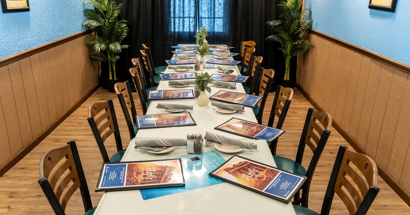 Private dining room with a long dining table set for guests