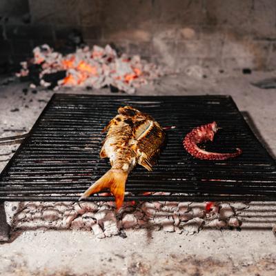 Branzino and octopus leg  getting grilled.