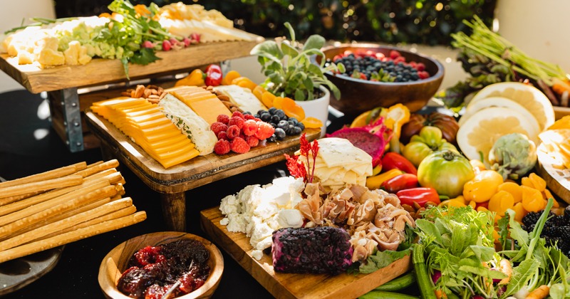 Catering food table with vegetables, fruits and cheeses