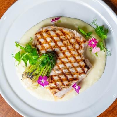Grilled swordfish dish plate, top down view.