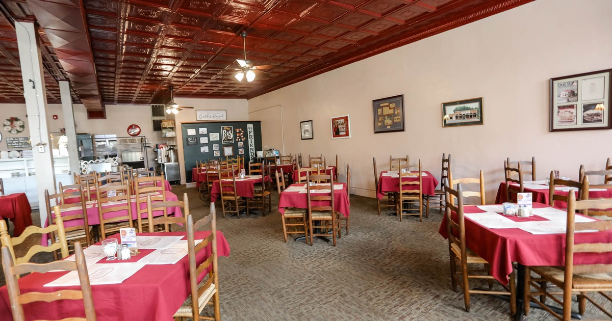 Interior, chairs and tables with red tablecloths