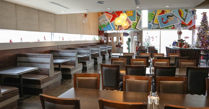 Inside, booths, tables, and a decorated bar area