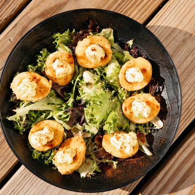 Boiled Eggs topped with cream, served on lettuce