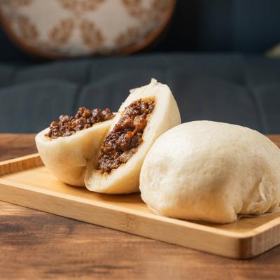 Meat pies on a wooden board.
