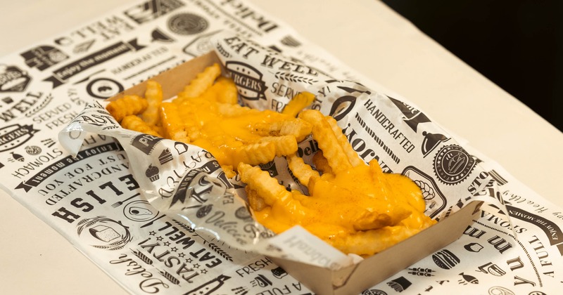 Crinkle-cut french fries covered in a rich, melted yellow cheddar cheese sauce