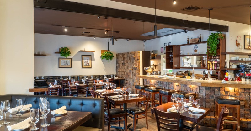 Interior, dining area, white cloth tables for four and two, ready for guests