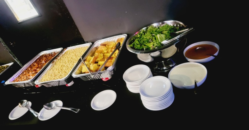 Assorted buffet food plates and tableware on a table