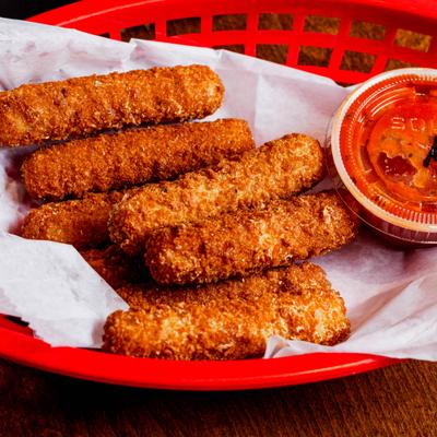 Mozzarella Sticks served with a side of marinara sauce.