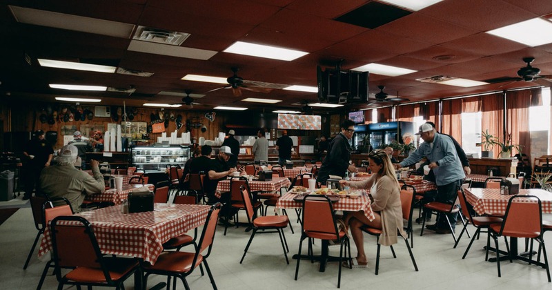 Interior, wide view, dining area, guests sitting and enjoying their food