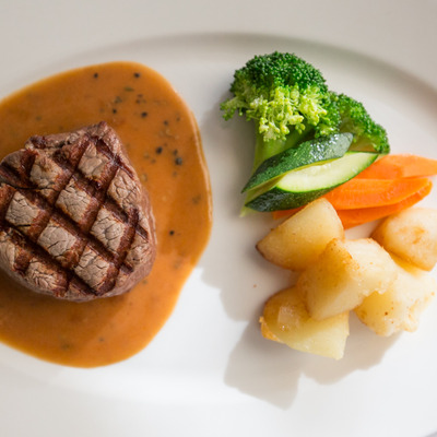 Filet Mignon, with potatoes, carrots, cucumber, and broccoli.