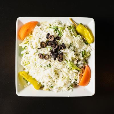 Salerno's salad of greens, black olives, mushrooms, pepperoncini, tomato, mozzarella and Romano