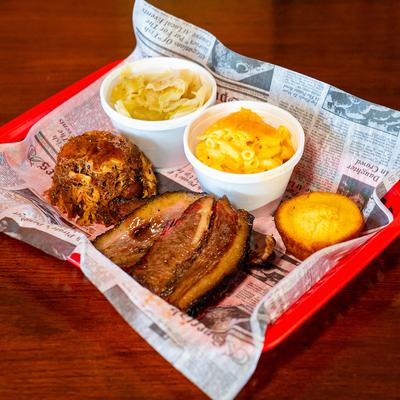 Brisket and pulled pork combo plate with mac and cheese, cabbage, and cornbread.