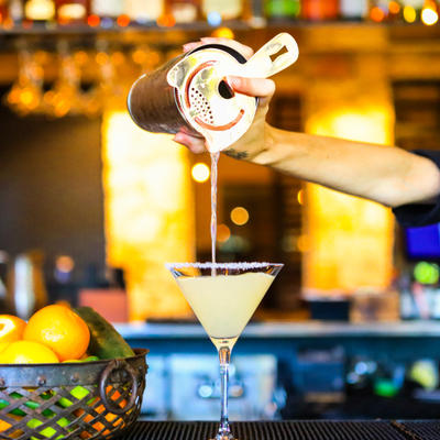 Staff member pouring cocktail