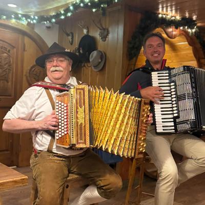 Two musicians playing accordions.
