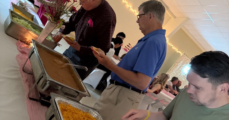 People serving themselves at a buffet