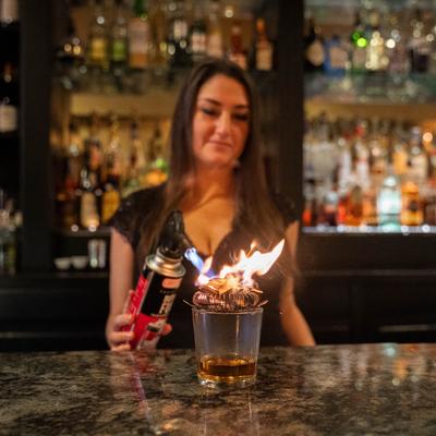 bartender smoking whiskey.