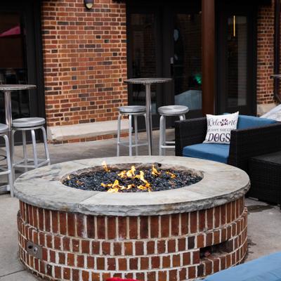 Outdoor stone fire pit with seating.
