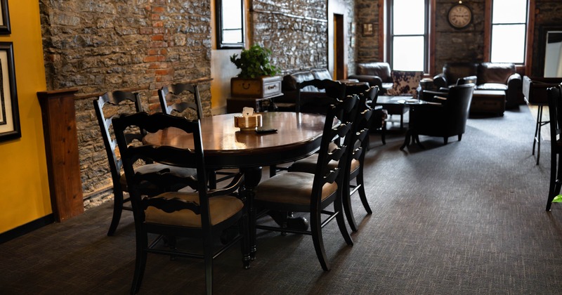 Cozy dining area with a round wooden table surrounded by black chairs