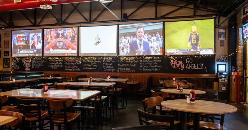 Inside, tables, chairs, TV screens