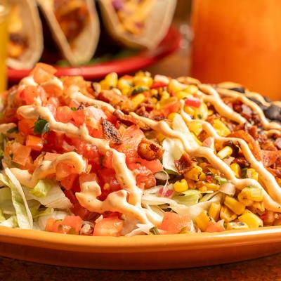 Southwest Cobb Salad, with lettuce, bacon, beans, corn salsa, pico, scallions, and chipotle ranch.