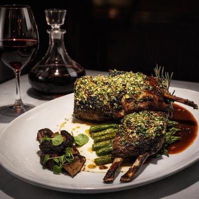 Pistachio-crusted rack of lamb served with asparagus and red wine.