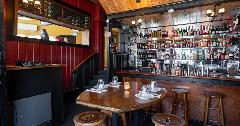 Interior, table with chairs, bar in the back