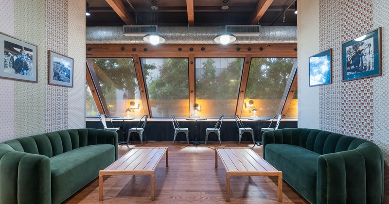 Interior, upstairs lounge area, two three-seater sofas with coffee table, framed pictures