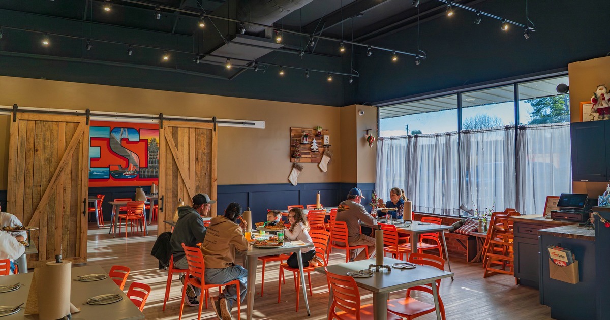 Colorful and bright dining area with orange chairs