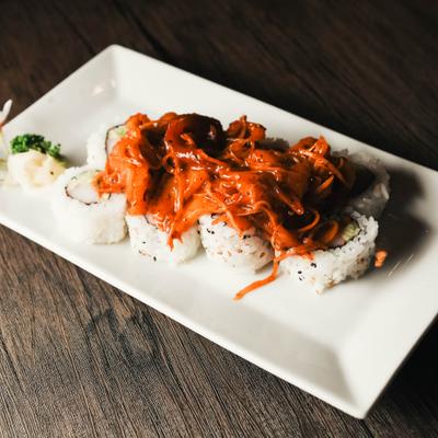 A type of sushi roll topped with a creamy, spicy sauce.
