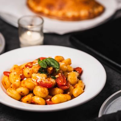 Potato gnocchi with cherry tomatoes and basil.