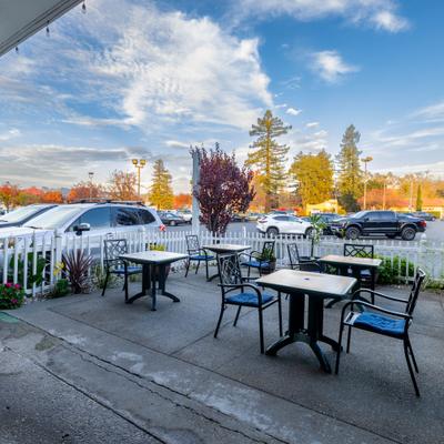 Outdoor patio with tables amd chairs.