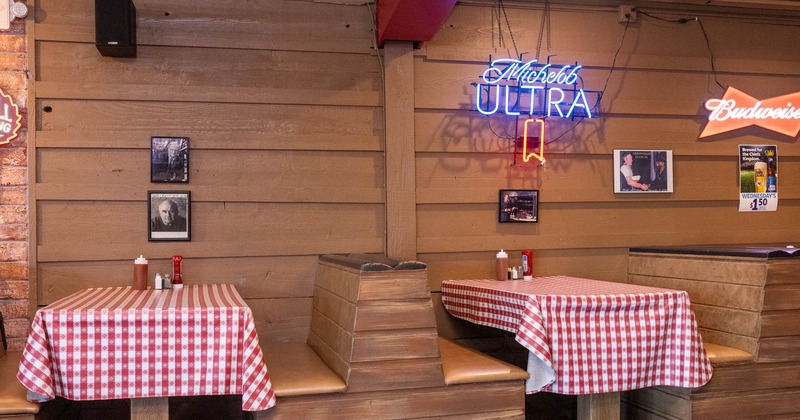 Interior, dining area, seating booths, wood coated walls with autographed framed photos